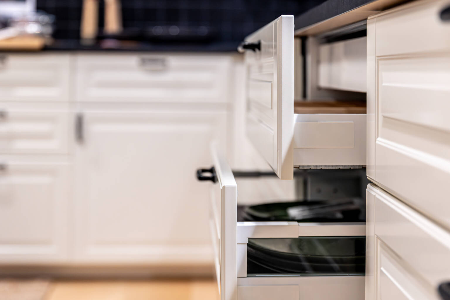 Open kitchen drawer with dishes inside showing everyday cabinet use
