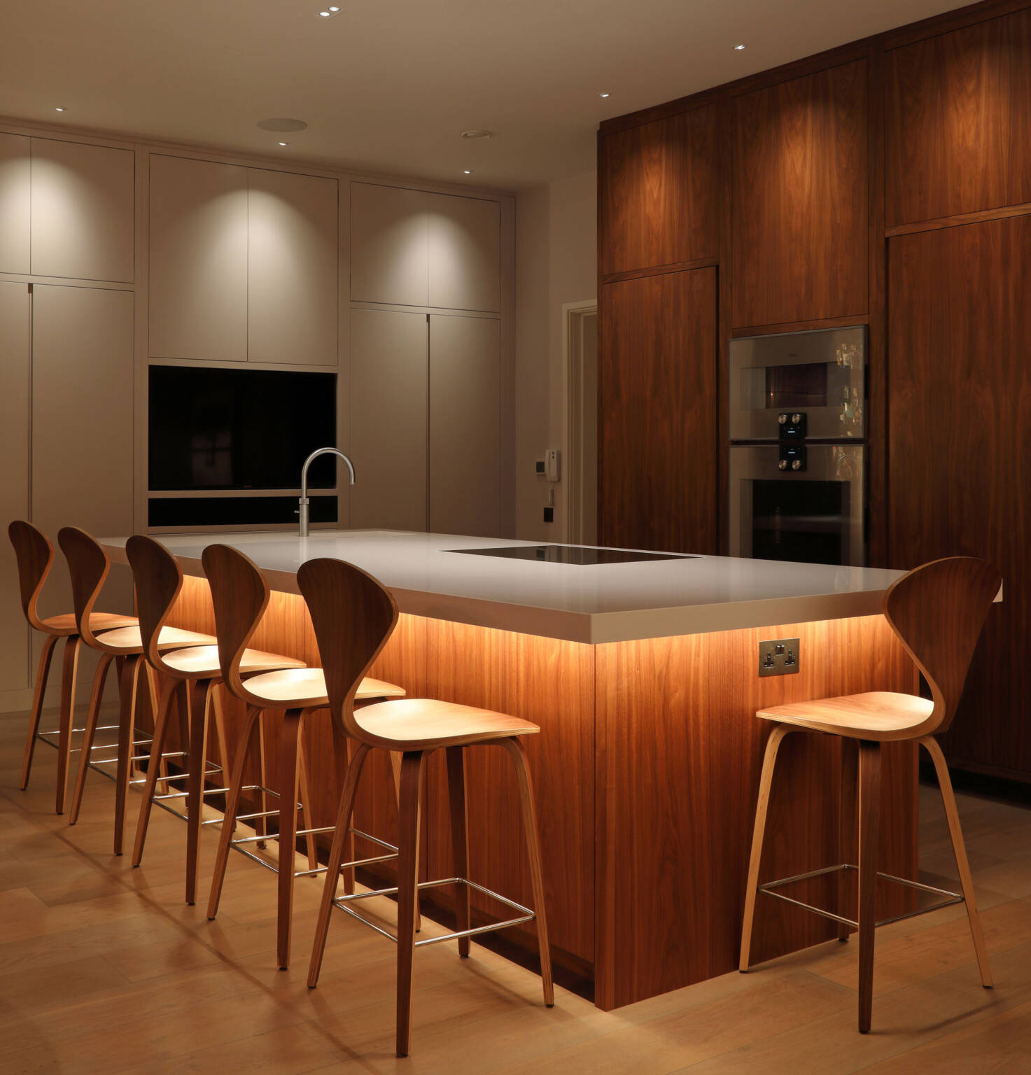 Ambient ceiling lighting in a modern Malaysian kitchen with neutral white tones