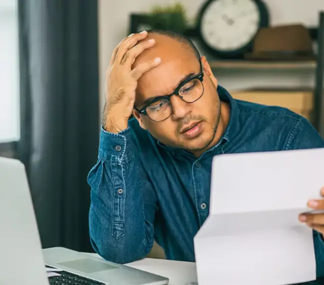 homeowner stressed looking at invoice of renovation bill