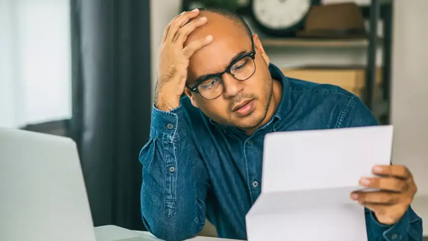 homeowner stressed looking at invoice of renovation bill