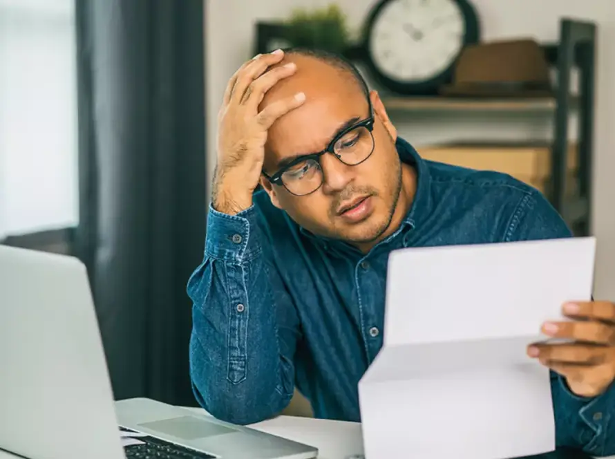 homeowner stressed looking at invoice of renovation bill