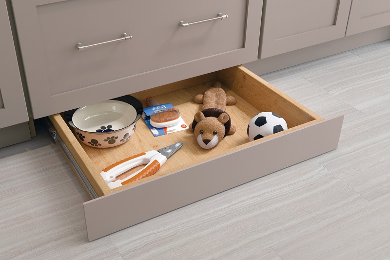 Toe-kick drawer open at base of kitchen cabinets