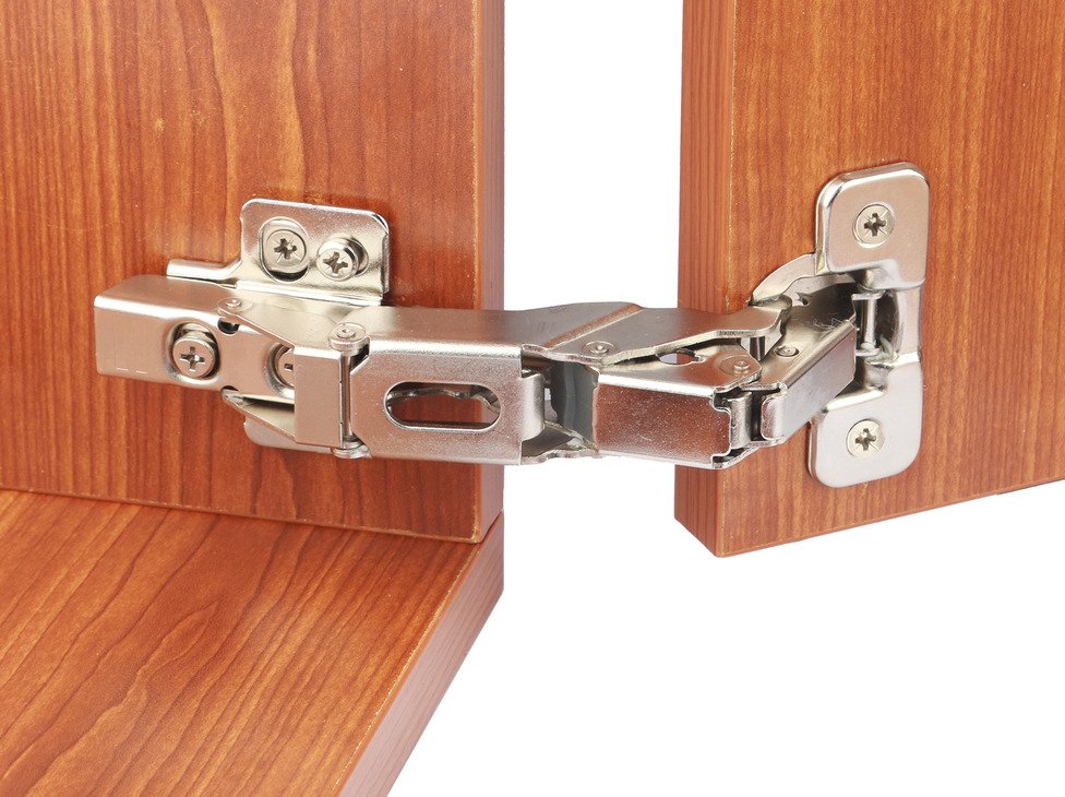 Concealed cup hinge installed inside a kitchen cabinet door
